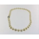 A cultivated South Sea pearl necklace with a white gold locket set with brilliant cut diamonds,