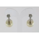 A pair of white gold earrings mounted with pearl South Sea 13 x 14mm. brilliants 0.39ct. 18kt.Een