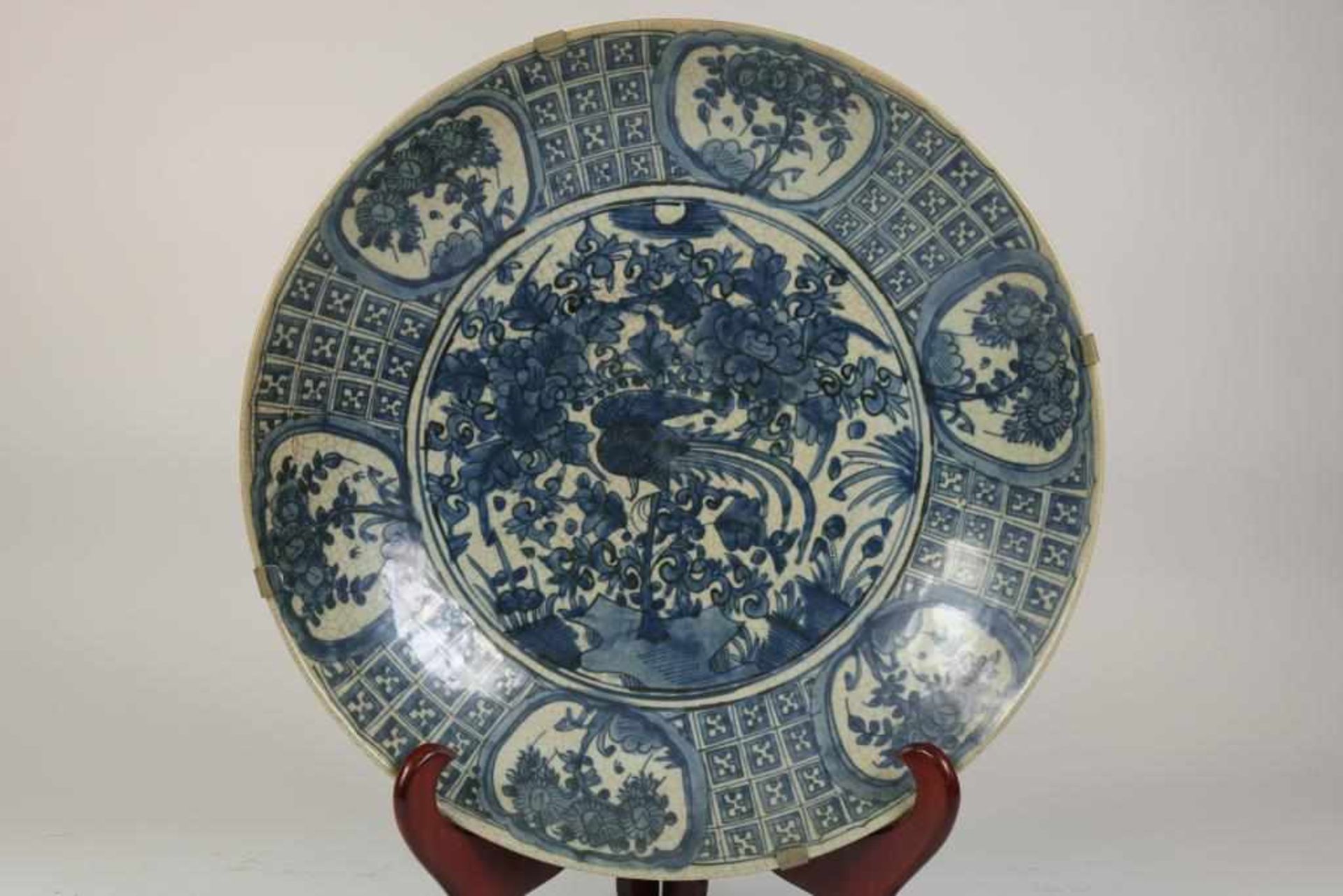 A Chinese 'Swatow' porcelain charger, decorated with a phoenix standing in a garden. Ming period,