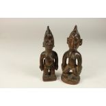 a pair of wooden Yoruba twinfigures, Abeokuta, Ibeji, Nigeria, h. 22 cm.Stel houten Yoruba