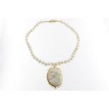 A cultivated pearl necklace with shell cameo in golden mount and golden lock, 585/000, gross w. 99.