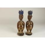 a pair of wooden Yoruba twinfigures, Ibeji, Nigeria, h. 26 cm.Stel houten Yoruba vrouwelijke