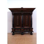 Mahogany and ebony pillow cabinet with medallion of family crest, carved frieze with angels and coat