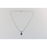 A fine white gold necklace en pendant set with sapphire, ca. 0.60ct, and brilliant cut diamonds,