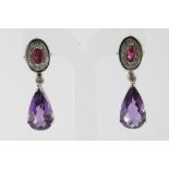 A pair white gold earrings set with amethist, diamonds and ruby, gross w. 13.2gr, length 4cm.Een