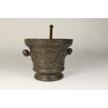 Cast bronze mortar decorated with relief decor devil's heads and equipped with handles in the form