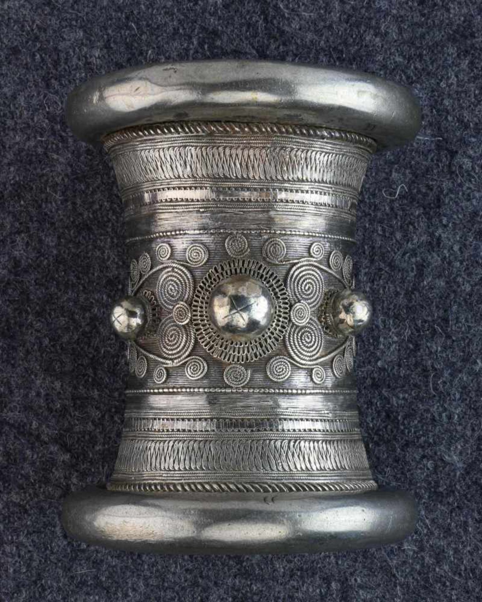 Myanmar, silver tubular braceletwith three knobs, geometrical decoration and spirals. Lit. ref.