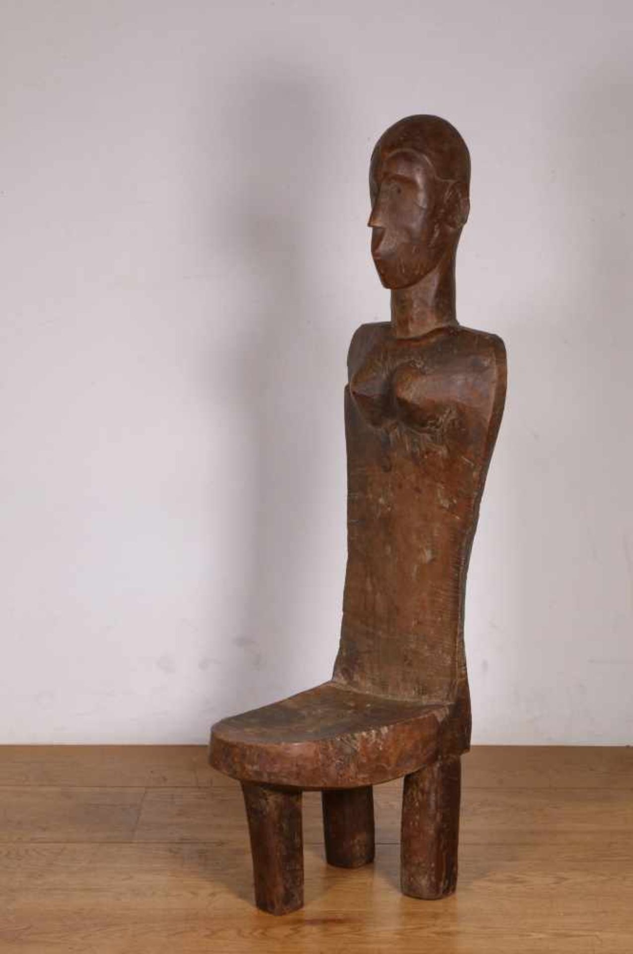 Tanzania, Pare, wooden restwith high back with carved female figure., h. 95 cm. [1]400