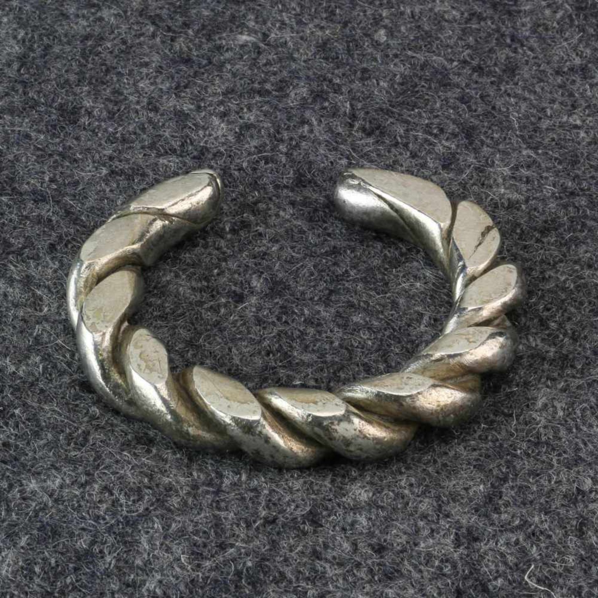 Golden Triangle, a hollow silver bracelet and a pair of flat spiral solid silver bracelets;the