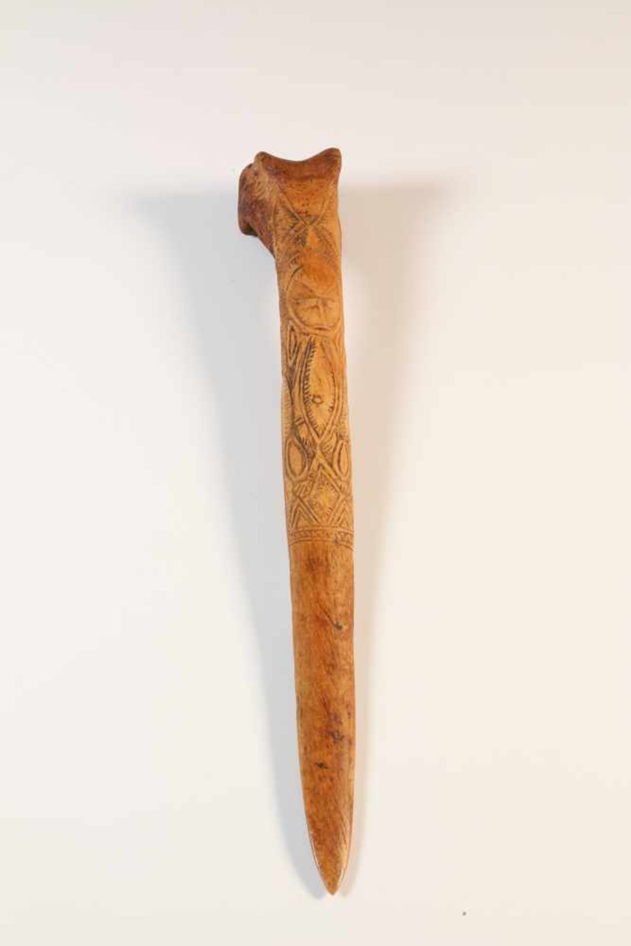PNG, Abelam, ceremonial bone daggerwith carved ancestral figure, l. 35 cm. [1]300