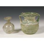 A large Roman glass beaker with two ears, 2nd-3rd century and a small thin Roman glass sprinkler, 3r