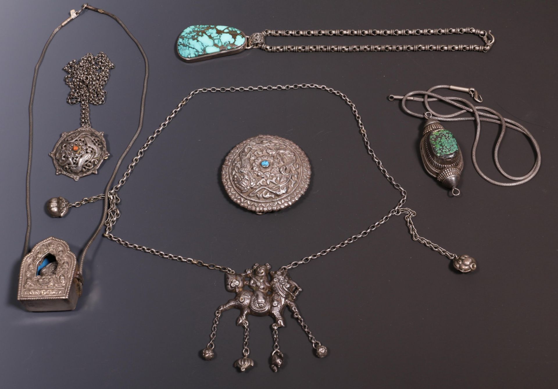 Tibet, collection of five silver chained necklaces with big pendants and one pendant with small turq