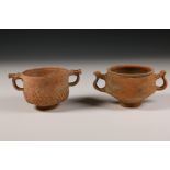 Two Hispano-Roman red earthenware beakers with handles, 1st-3rd century,