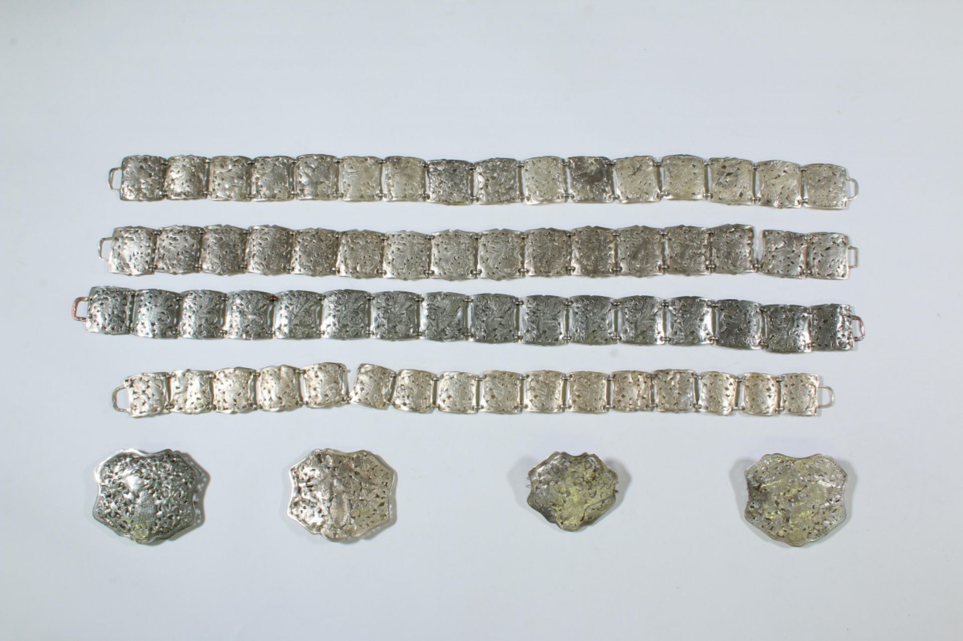 Southeast Asia, four silver alloy belt chains and four fitting belt buckles