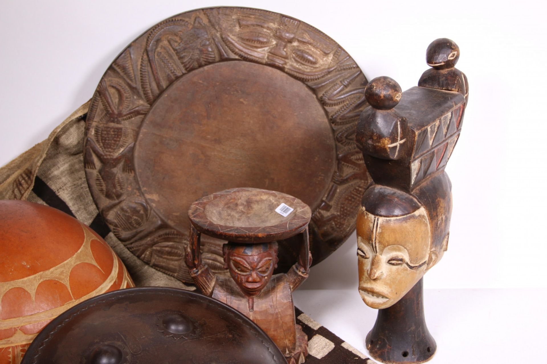 Nigeria, Yoruba, wooden Ifa dish decorated with carved faces.and a neckrest-like bowl