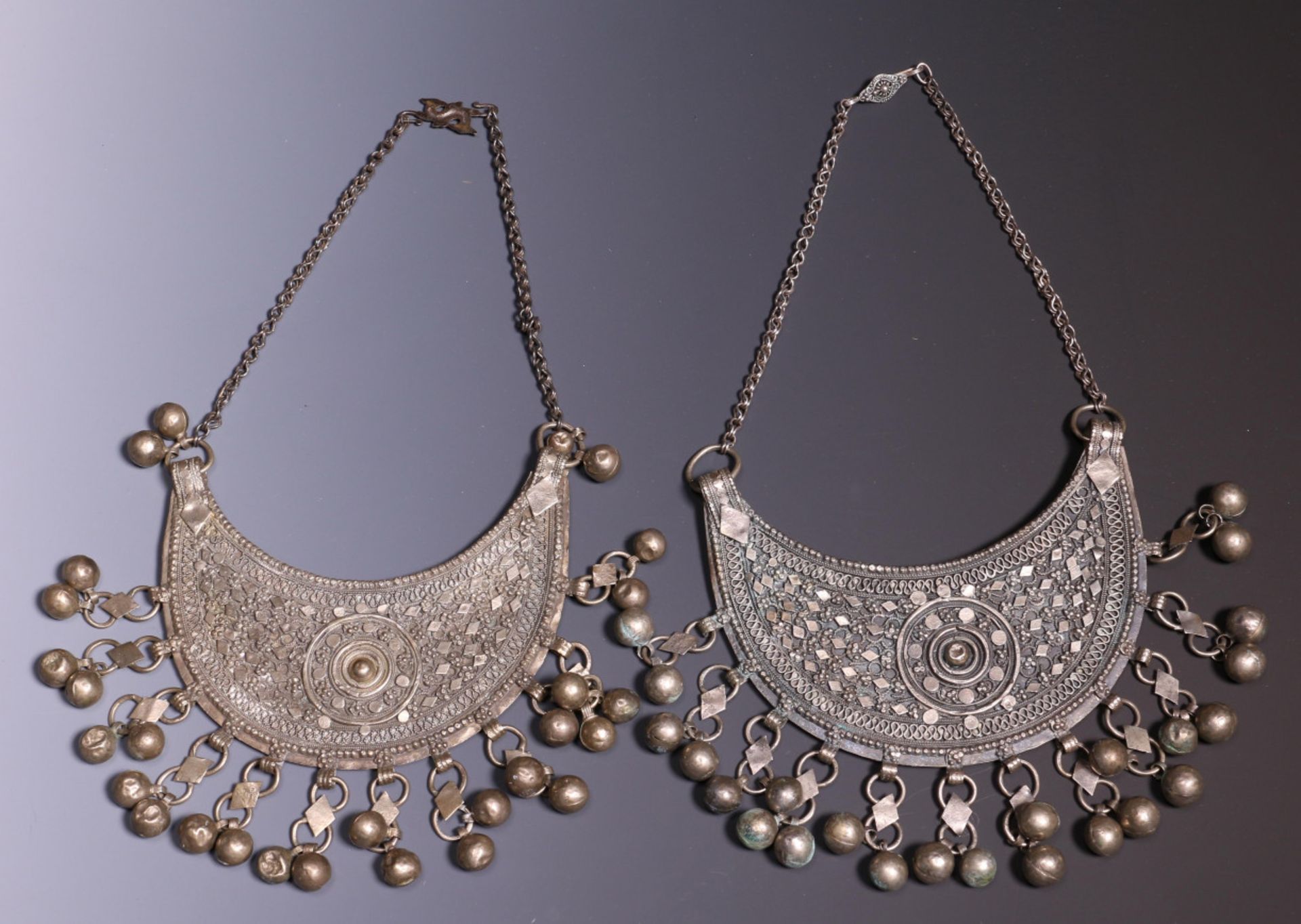 Jemen, pair of silver alloy necklaces, half-moon shaped with bells, on a chain