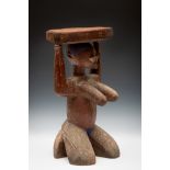 Nigeria, Yoruba, Igbomina, Oro, seat stylised as an Arugba figure, partly encrusted patina, the body