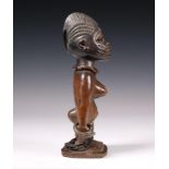 Nigeria, Yoruba, Awori, Ado Odo, ibeji, female twin figure, wearing metal armlets.