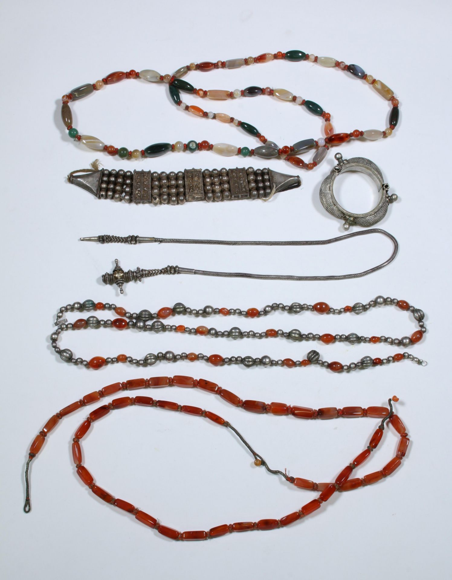 Southeast Asia, collection of three long necklaces with cornealines, one silver alloy belt and two b