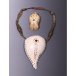 India, Naga, cut and decorated Turbinella shell on a chain with two quartz beads and Timor, a decora