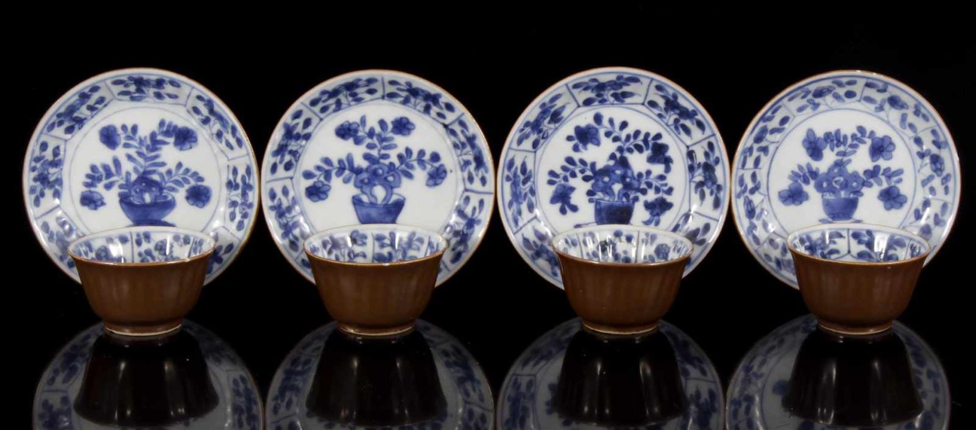 4 Chinese porcelain cafe au lait bowls and saucers with blue decor plant in flower pot on table