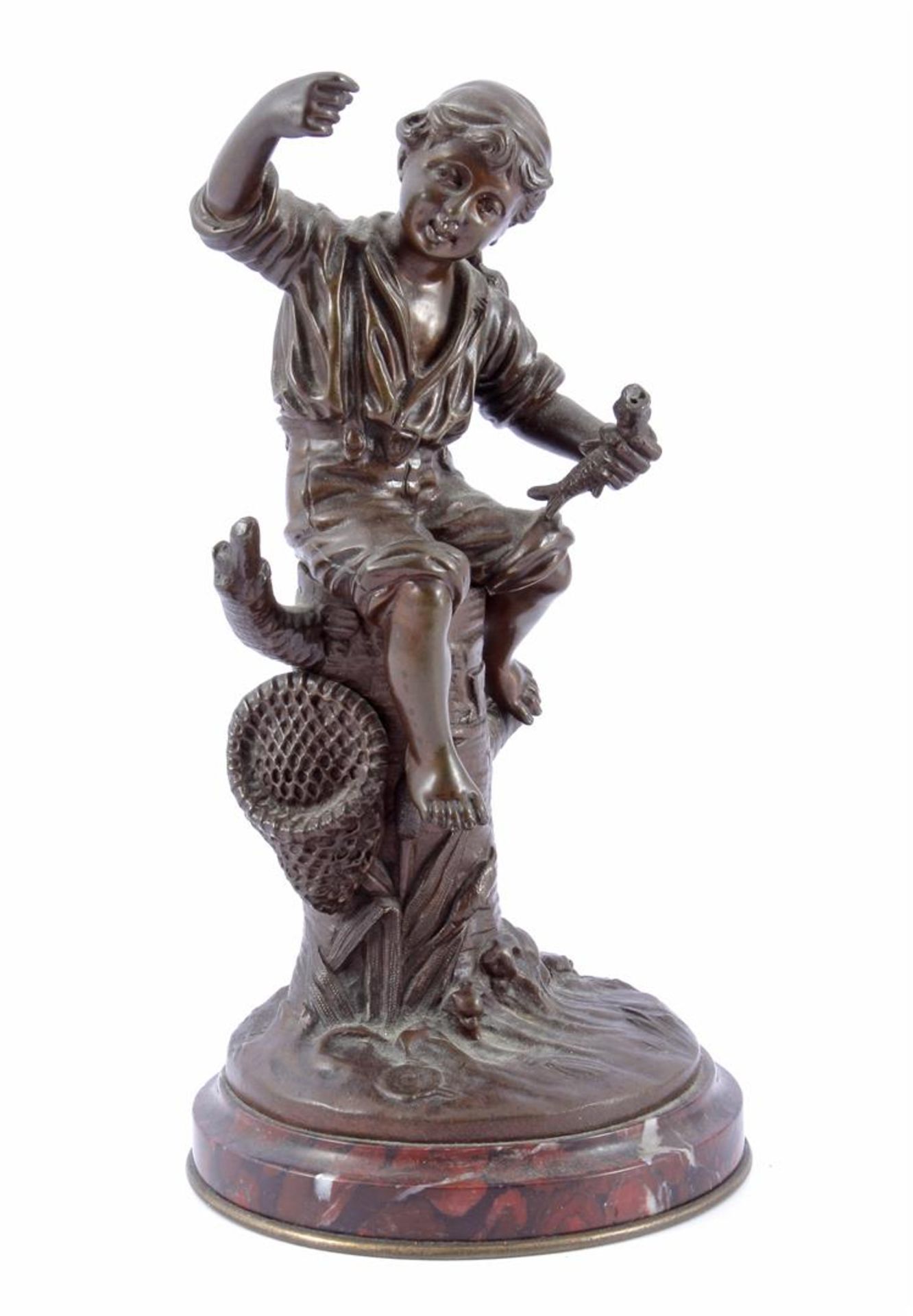 Anonymous, bronze sculpture of a boy, sitting on a tree stump, holding a fish in one hand, the other