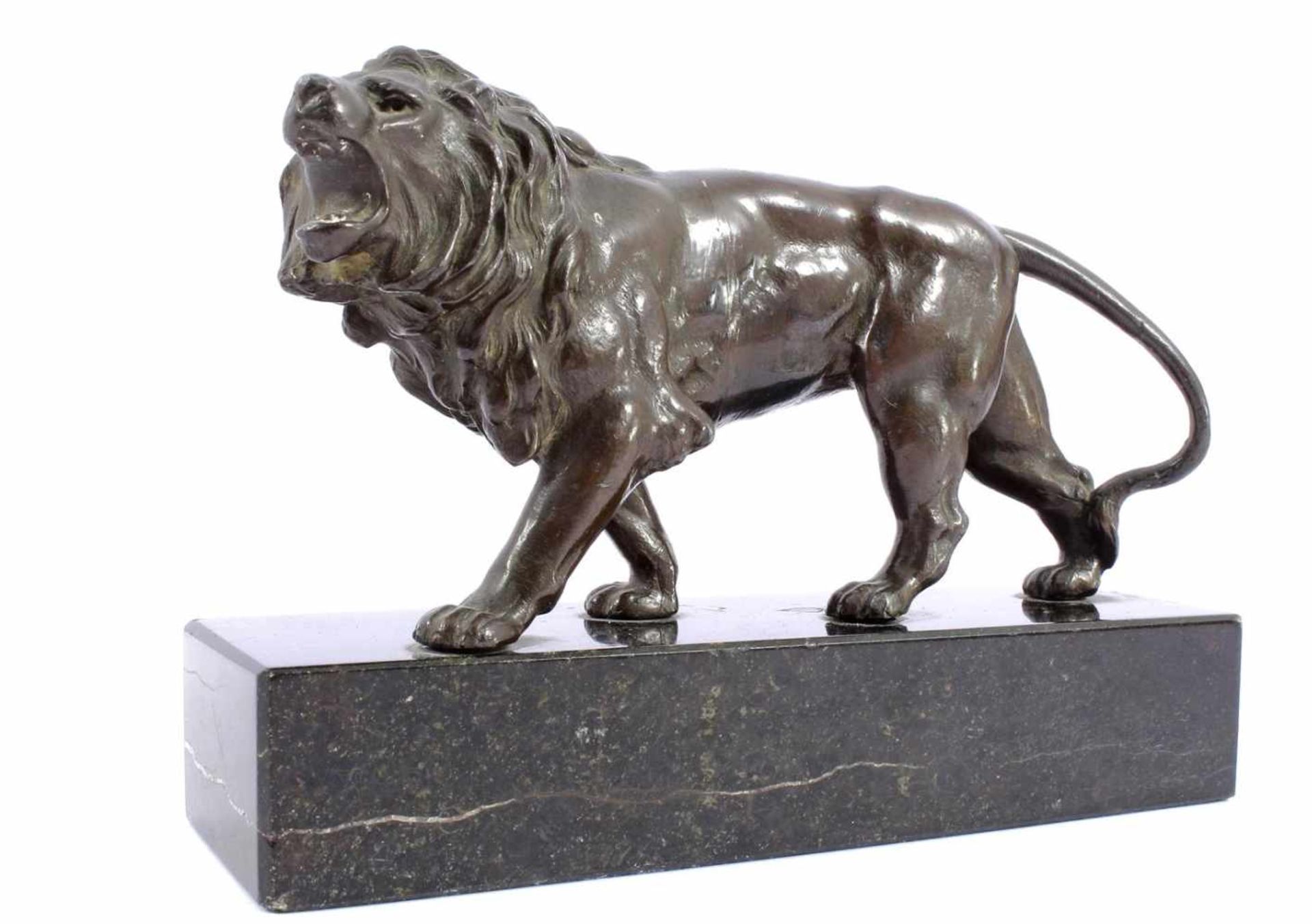 Bronze colored metal statue of a lion, standing on a marble base 12 cm high, 18 cm long