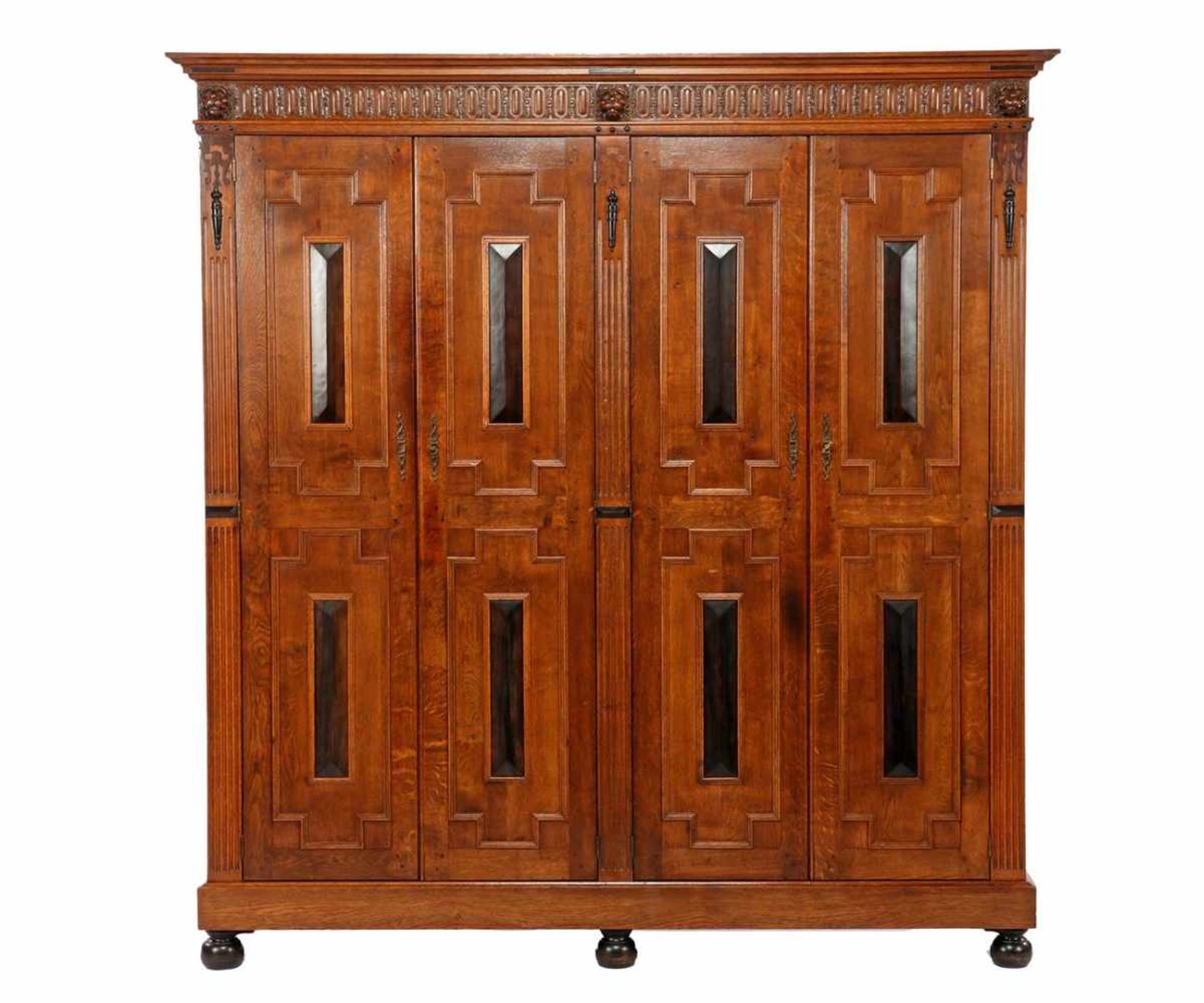 Oak 4-door cabinet with Renaissance-style features, carved frieze, lion masks, flutes, cushions