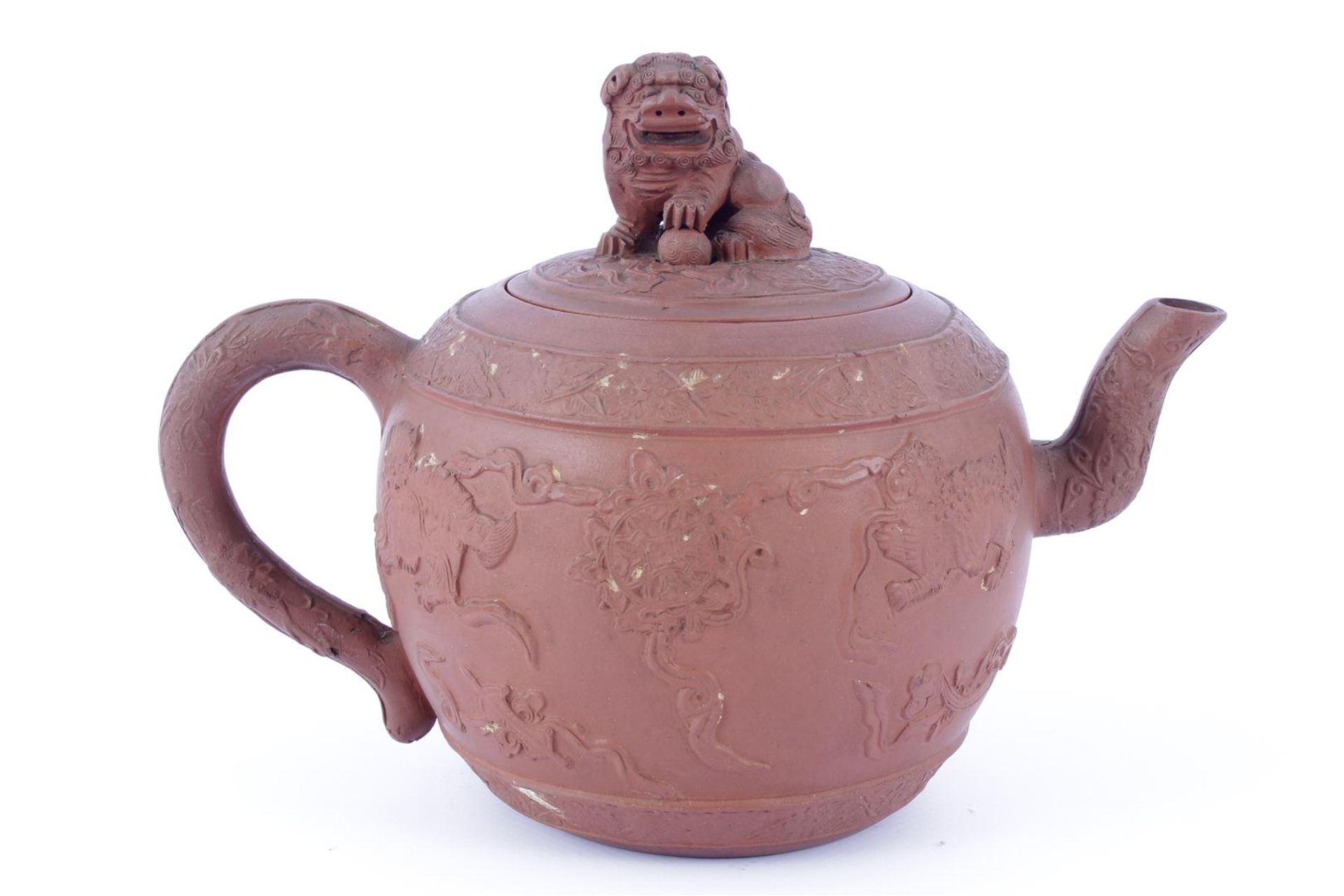 Yixing teapot with beautiful relief decor on the pouring spout, ear and around the pot. Cover