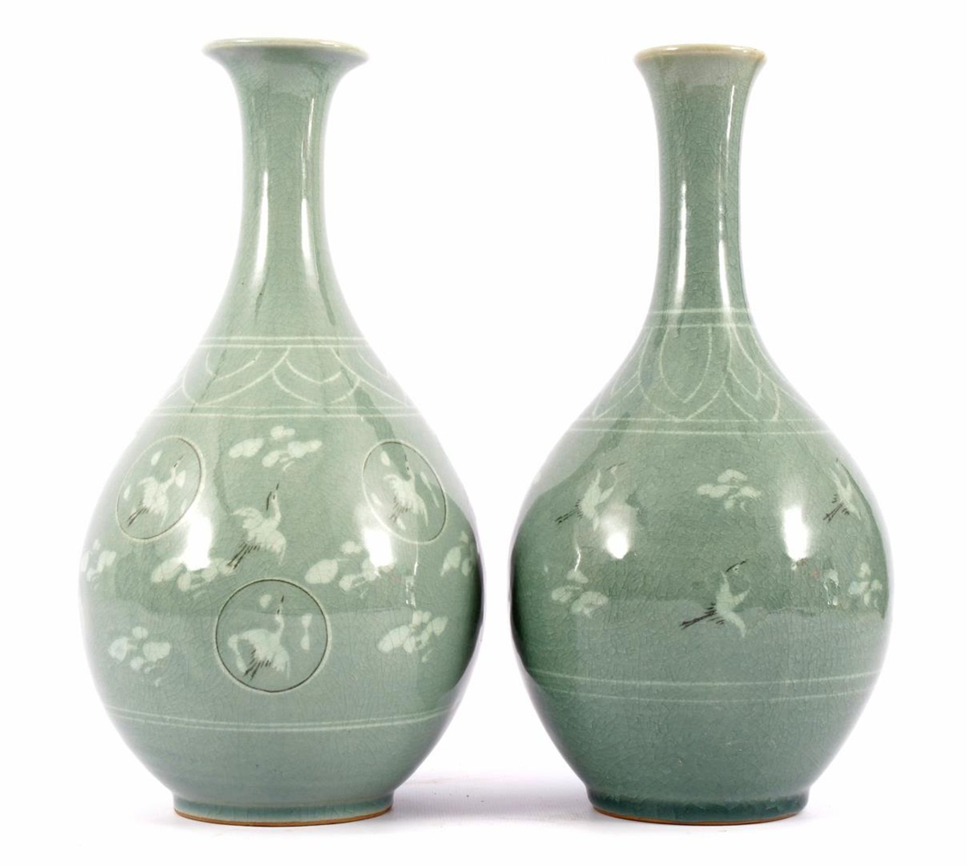2 Japanese porcelain green glazed vases decorated with flying herons and clouds, 30.8 cm high