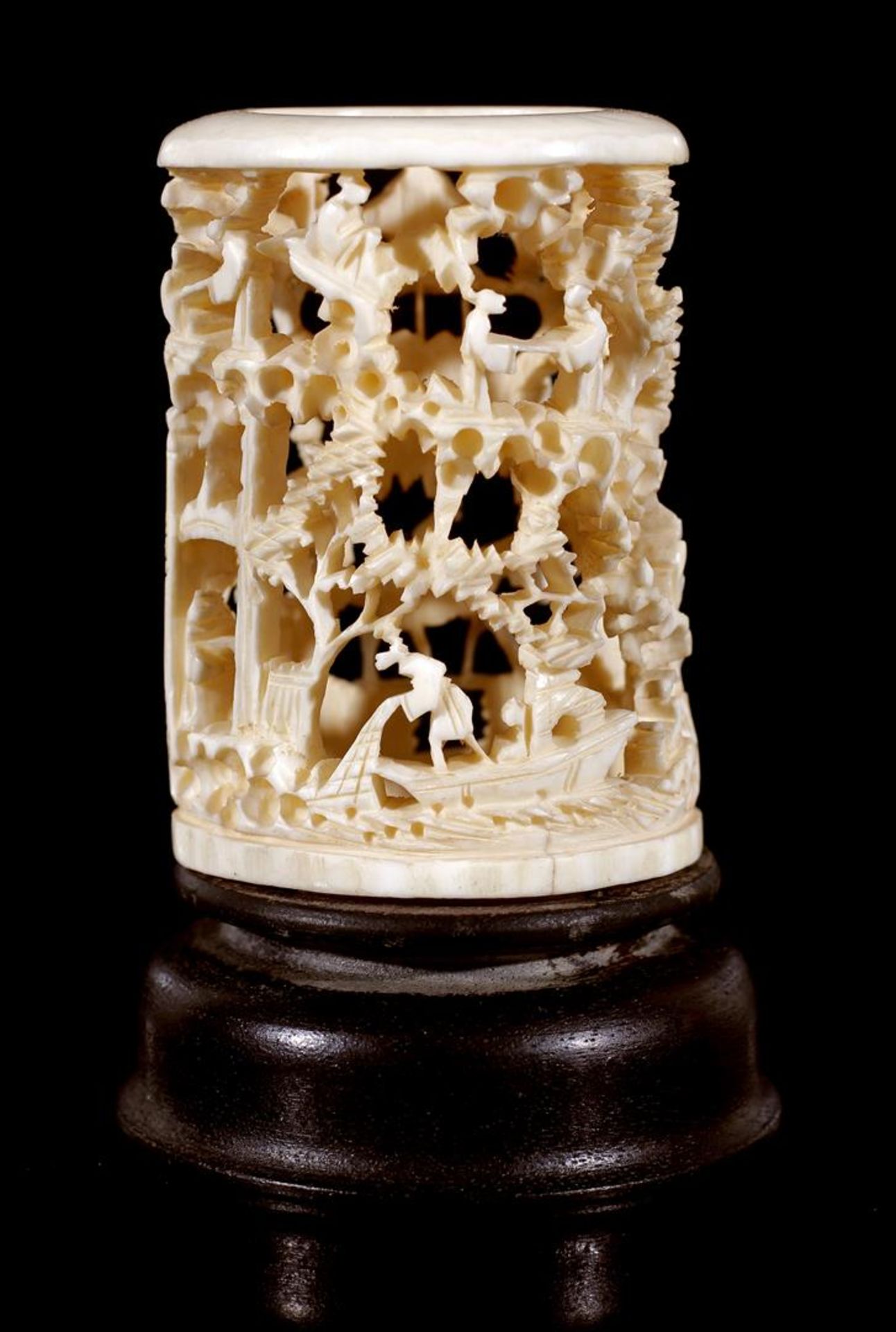 Richly carved ivory decorative object with landscape decoration, standing on wooden foot, China,