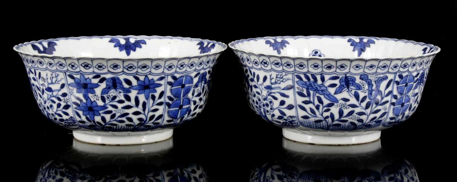 2 Chinese porcelain bowls with floral pattern, birds and butterflies, bottom marked with Kangxi 7.