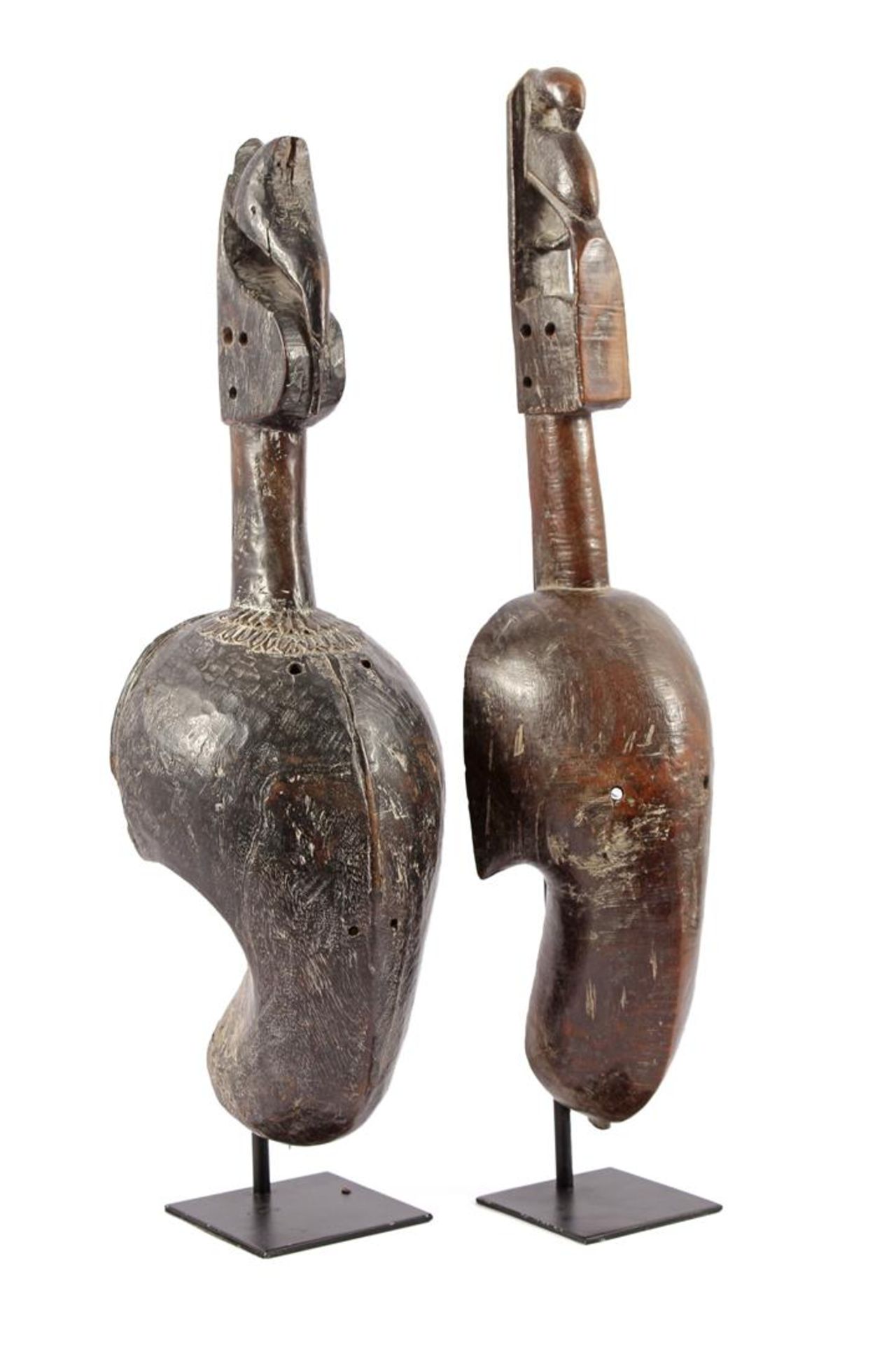 2 wooden elongated African masks on metal stand, 64 and 60 cm high