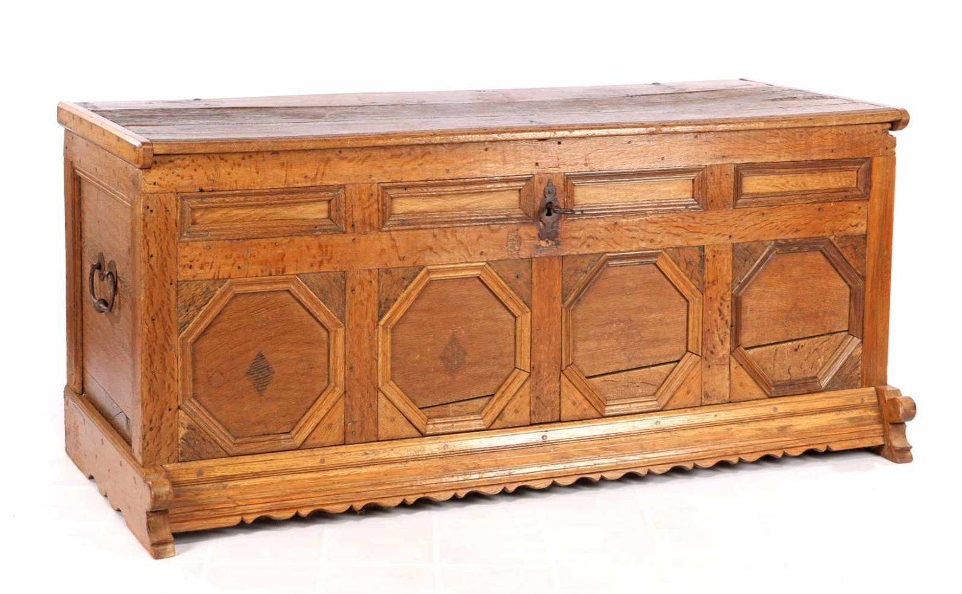 Oak blanket chest, standing on slippers and with a corrugated frame and wrought iron handles,