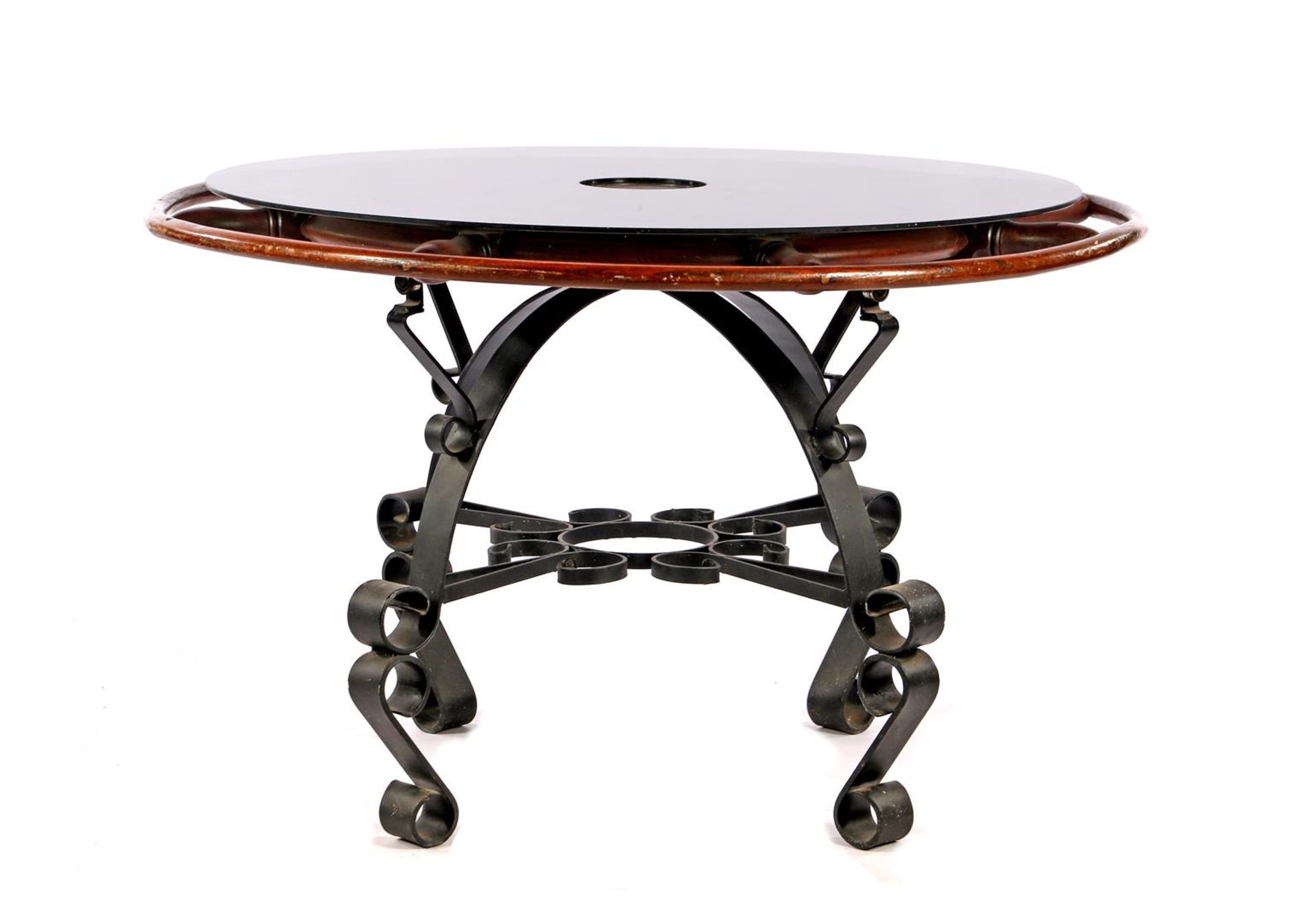 Special table consisting of walnut wheel with loose & nbsp; smoked glass top, lying on wrought