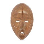Rare cast bronze Diomande / Dan miniature mask, Ivory Coast, 21 x 13 cm. These masks were cast by