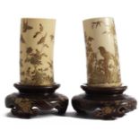 A pair of richly carved and decorated ivory ornaments with decoration of cranes in bamboo,