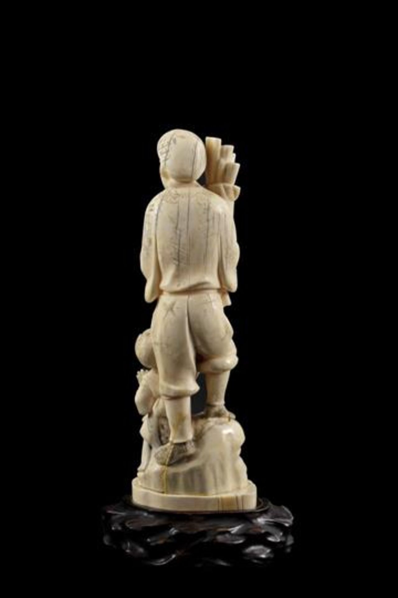Ivory carved sculpture of a man with child on a rock with a pack of branches in his hand, Japan, - Image 2 of 3