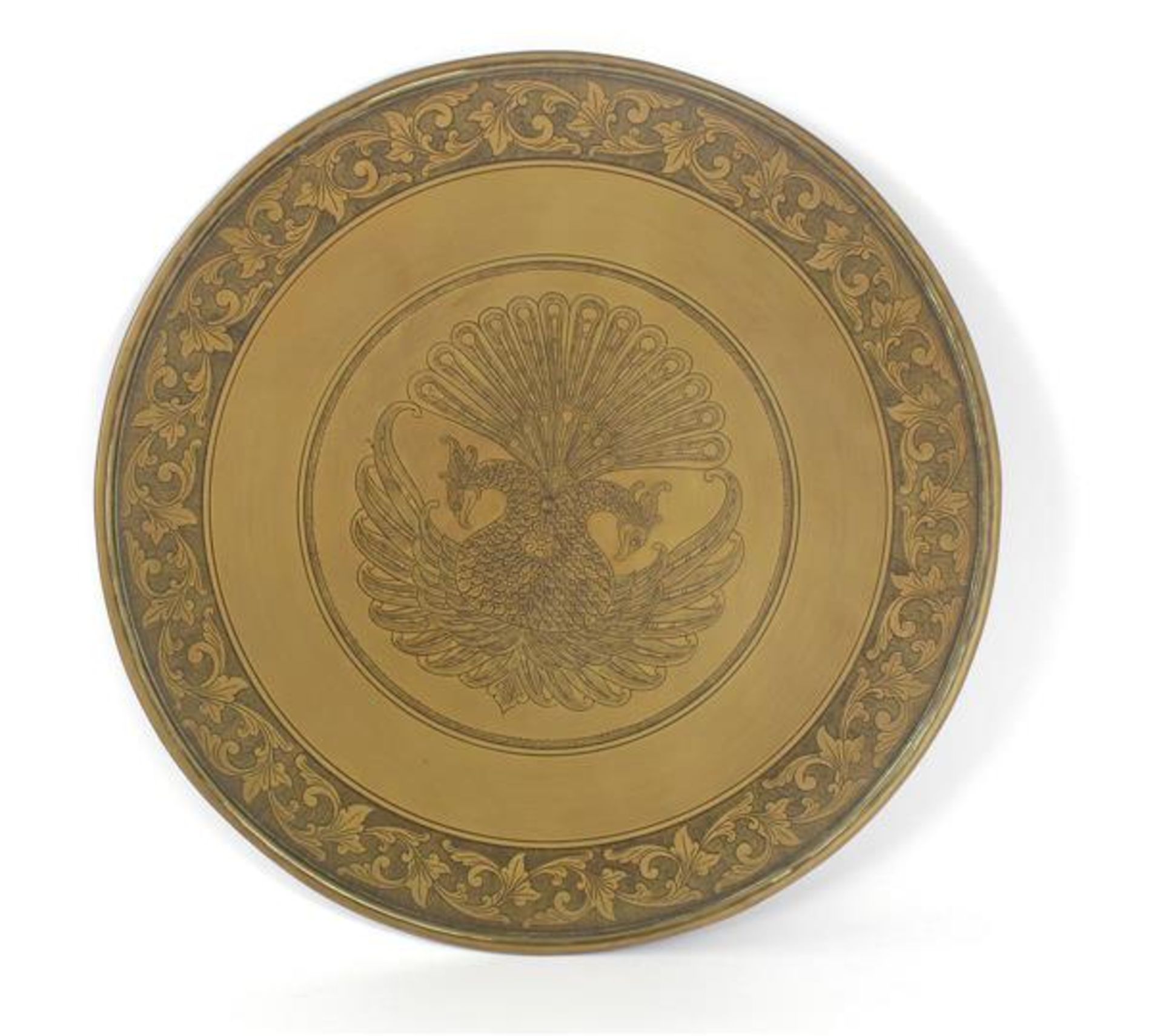 Brass wall dish with stylized decoration of peacocks in the middle and leaf decoration in the rim