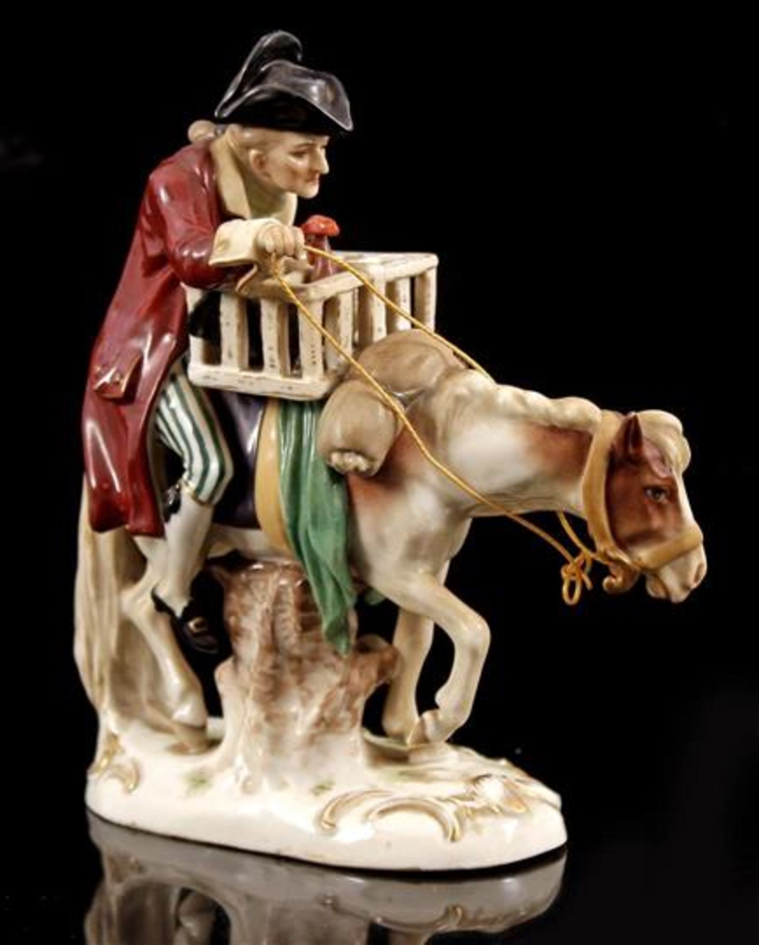 Porcelain group of statues of man on horse, cage with cock, marked bottom with mark Scheibe