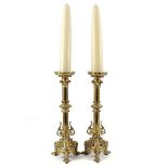 2 copper richly decorated pin candlesticks with dogs at the base 50 cm high, with 2 candles in total