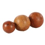 3 heavy leather balls, so-called medicine balls, 30, 29 and 22 cm in diameter