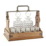 English oak tantalus with metal handle, 2 crystal whiskey decanters and 8 glasses 28.5 cm high