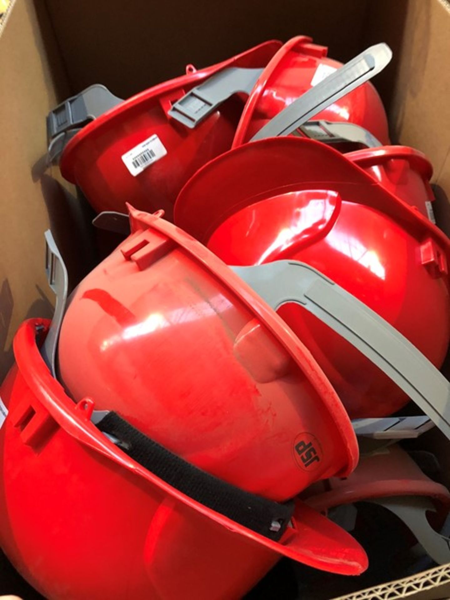 1 LOT TO CONTAIN AN ASSORTMENT OF JSP MANUFACTURING SAFETY HELMETS - RED (PUBLIC VIEWING AVAILABLE)