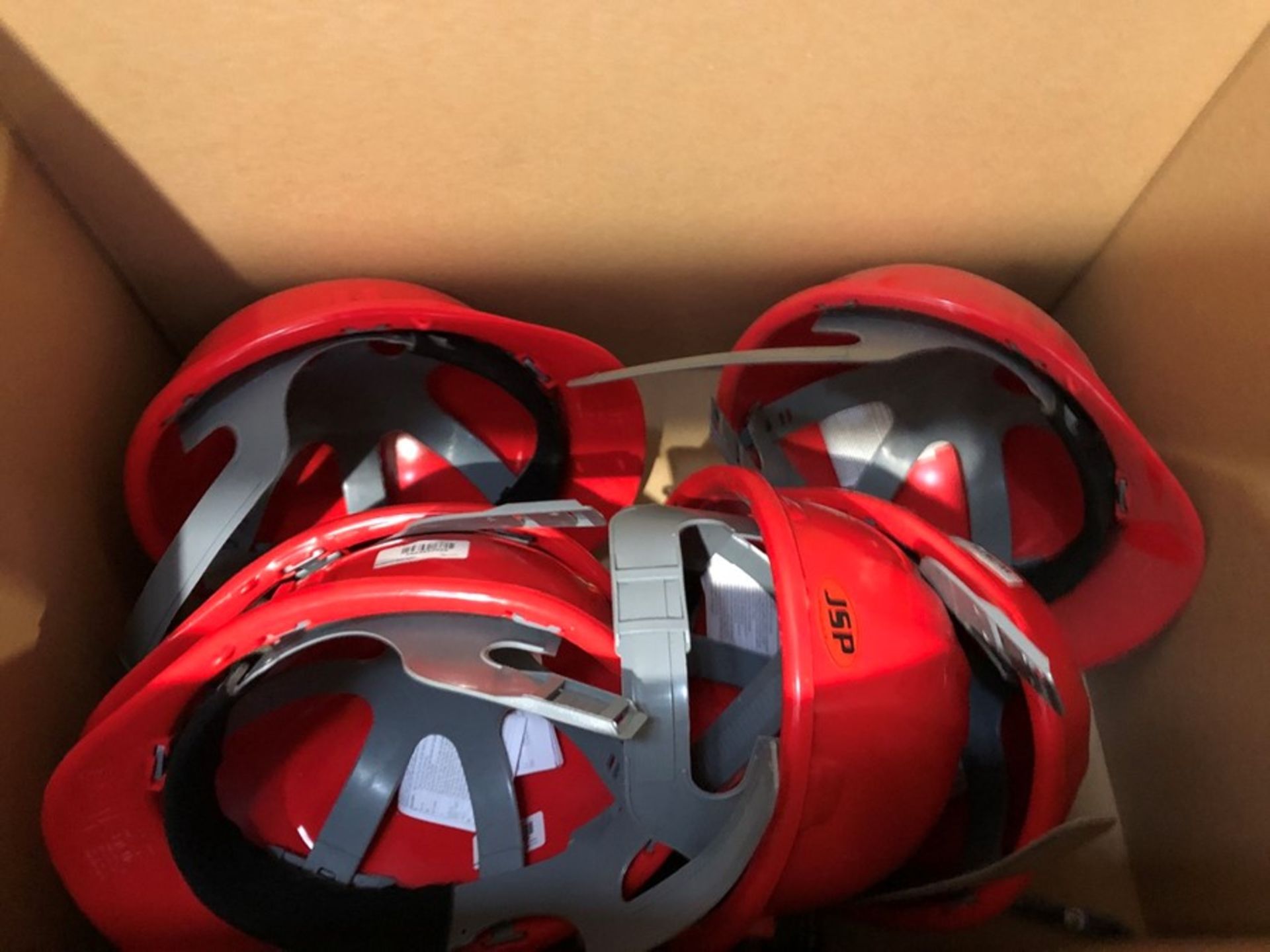 1 LOT TO CONTAIN AN ASSORTMENT OF JSP MANUFACTORING HELMETS - RED (PUBLIC VIEWING AVAILABLE)