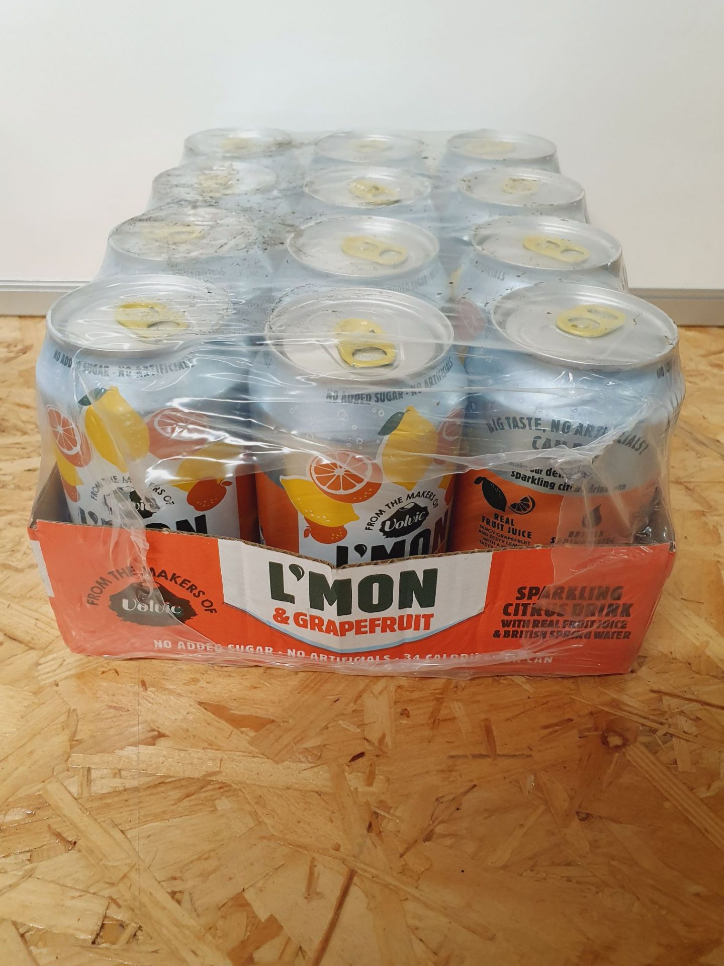 ONE LOT TO CONTAIN ONE CASE OF L'MON AND GRAPEFRUIT VOLVIC SPARKLING WATER. 12 CANS PER CASE, 330ML