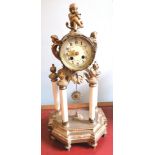 A 19th century drum mantle clock having a Roman numerical and enamel dial flanked by cherubs and