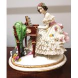 A late 19th century Dresden porcelain lace figure of a lady at a piano, having make mark to