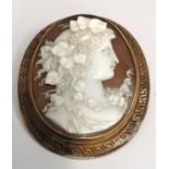 A fine oval 15ct (tested) mounted cameo of a lady with floral and grape accessories to hair. The