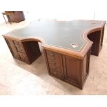 A 1920/30s mahogany and inlaid partners desk of large proportions, having a shaped top with inset